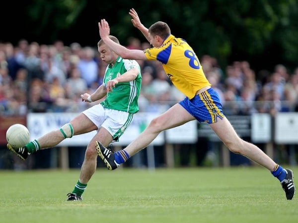 Sean McVeigh of London lets off a shot under pressure from Michael Finneran of Roscommon