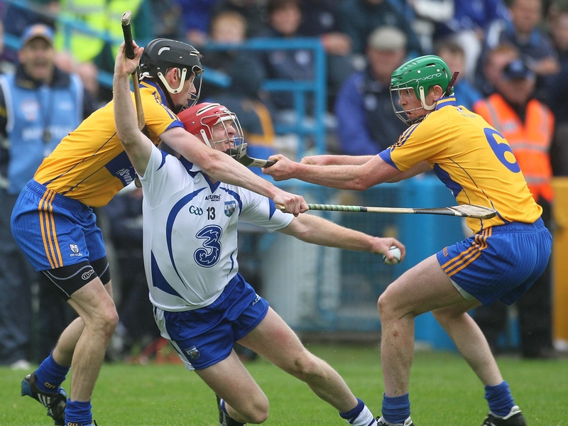 John Mullane of Waterford runs into company in the form of Clare's Pat Donnellan and Diarmuid McMahon