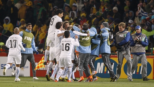 Alvaro Pereira celebrates a fabulous third goal for Uruguay in Pretoria in the day's final encounter
