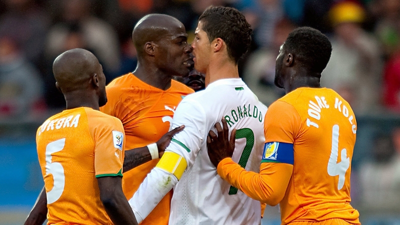 Cristiano Ronaldo of Portugal and Guy Demel of the Ivory Coast clash leading to yellow cards for both players