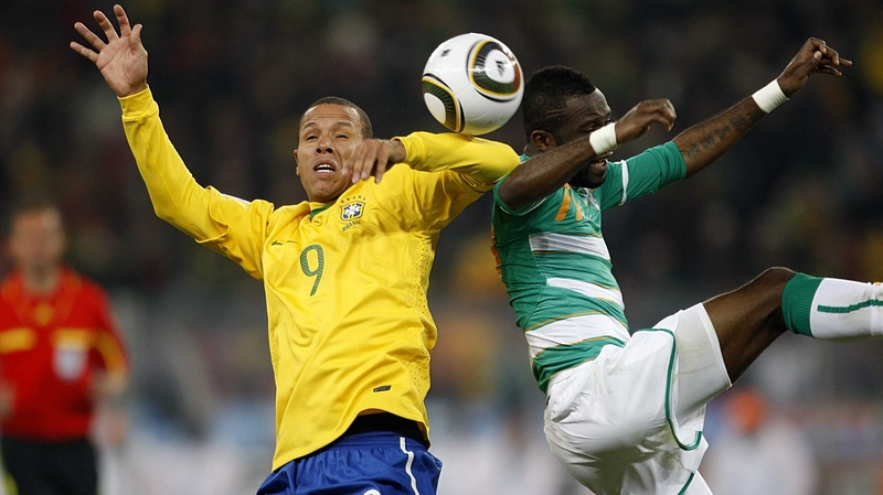 Brazil striker Luis Fabiano shows Ivory Coast's Siaka Tiene how to handle the ball and get away with it