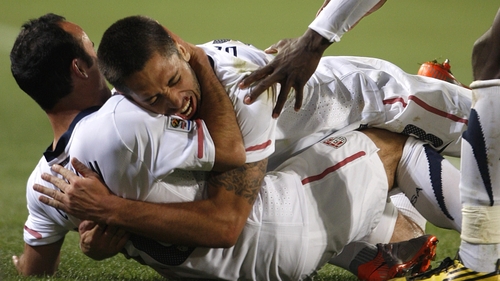 Clinton Dempsey jumps on Landon Donovan after his dramatic winner