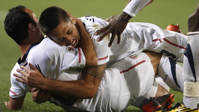 Clinton Dempsey jumps on Landon Donovan after his dramatic winner