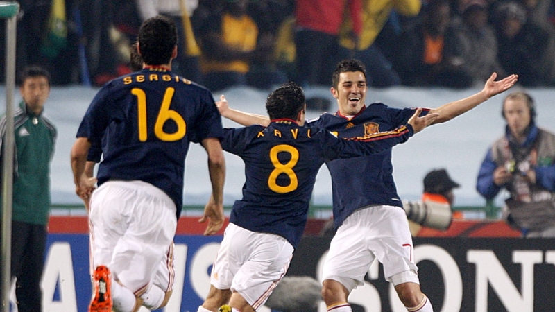 Spain's David Villa (right) celebrates scoring his sides first goal with team mates Sergio Busquets (left) and Hernandez Xavi (centre)