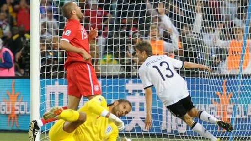 Germany's Thomas Mueller scores the fourth goal as England's goalkeeper David James and Matthew Upson look on dejected