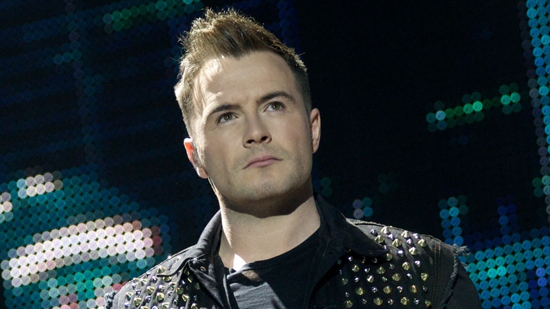 Shane Filan says that Louis Walsh kept them on the straight and narrow during the Westlife days, saying he was "very strict"