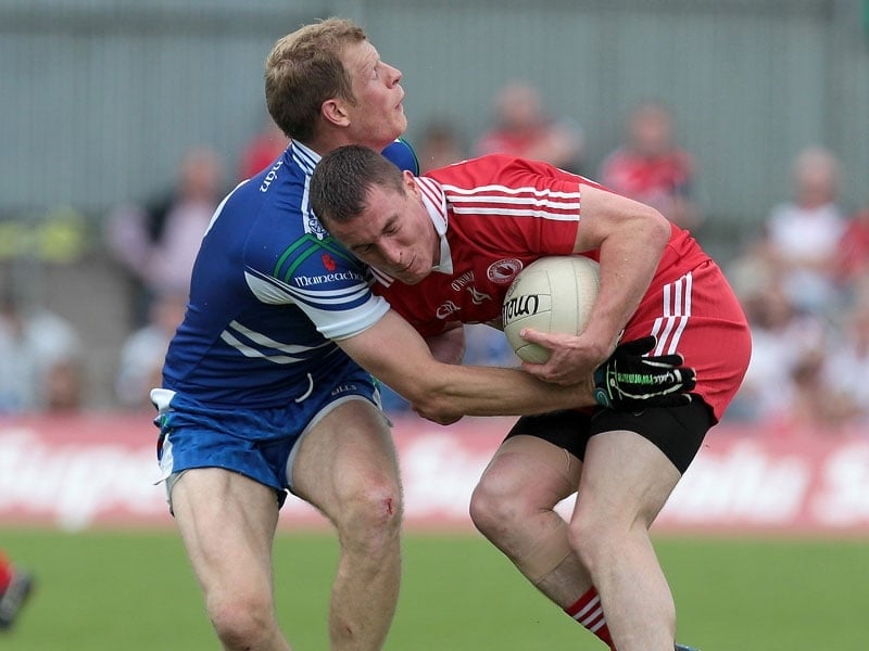 Owen Lennon of Monaghan and Tommy McGuigan of Tyrone grapple