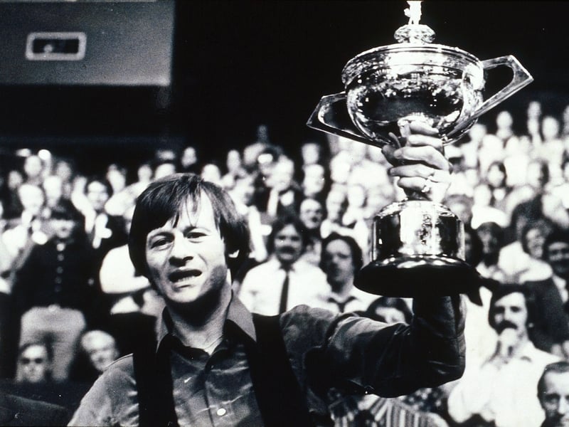 Alex Higgins lifts the World Championship trophy in 1982