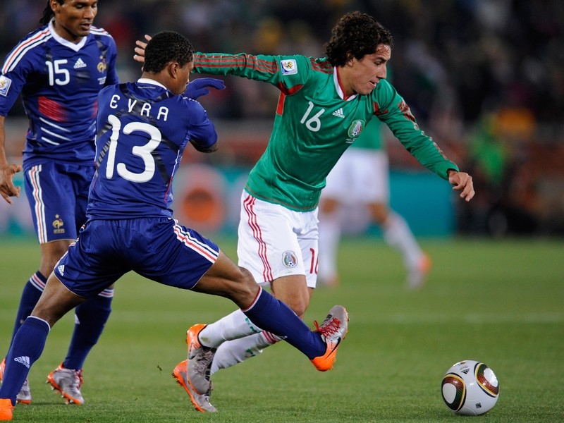 Efrain Juarez goes past Patrice Evra during the World Cup