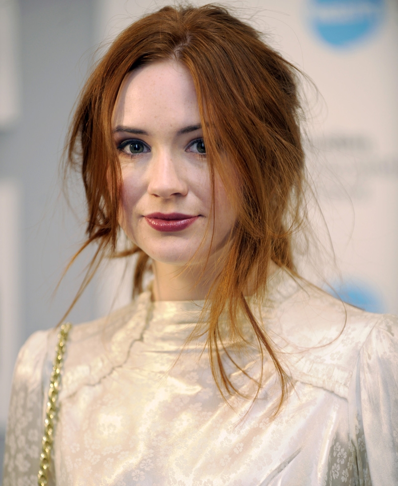 The deep plum lipstick lifts her complexion