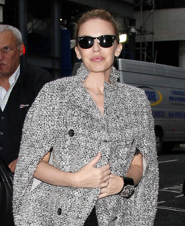 Kylie Minogue snuggles up in a grey tweed cape