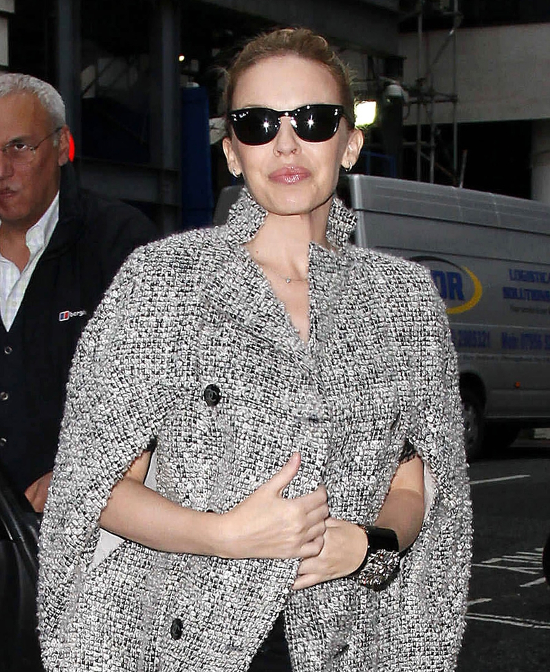 Kylie Minogue snuggles up in a grey tweed cape