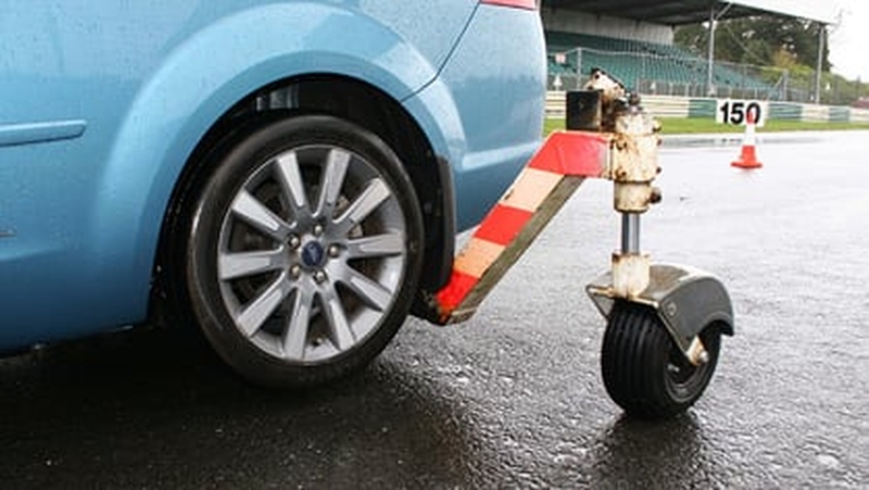 The car sits on an electronically controlled rig that has four 'outrigger' freewheeling castor wheels