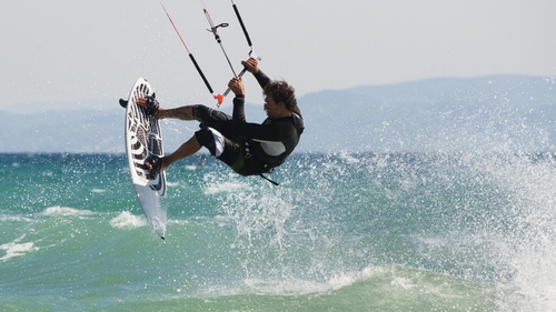 Kitesurfing - Surfers are pulled along at high speed with their feet on a board
