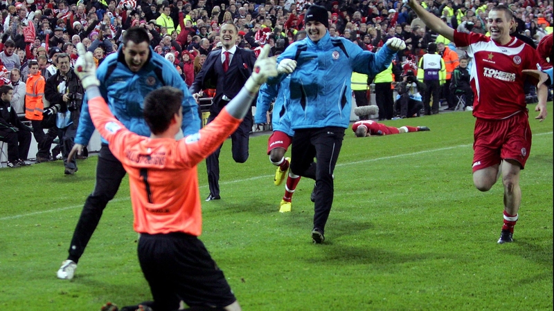 Ciaran Kelly is mobbed by his Sligo team-mates after saving a fourth penalty kick in the FAI Ford Cup final