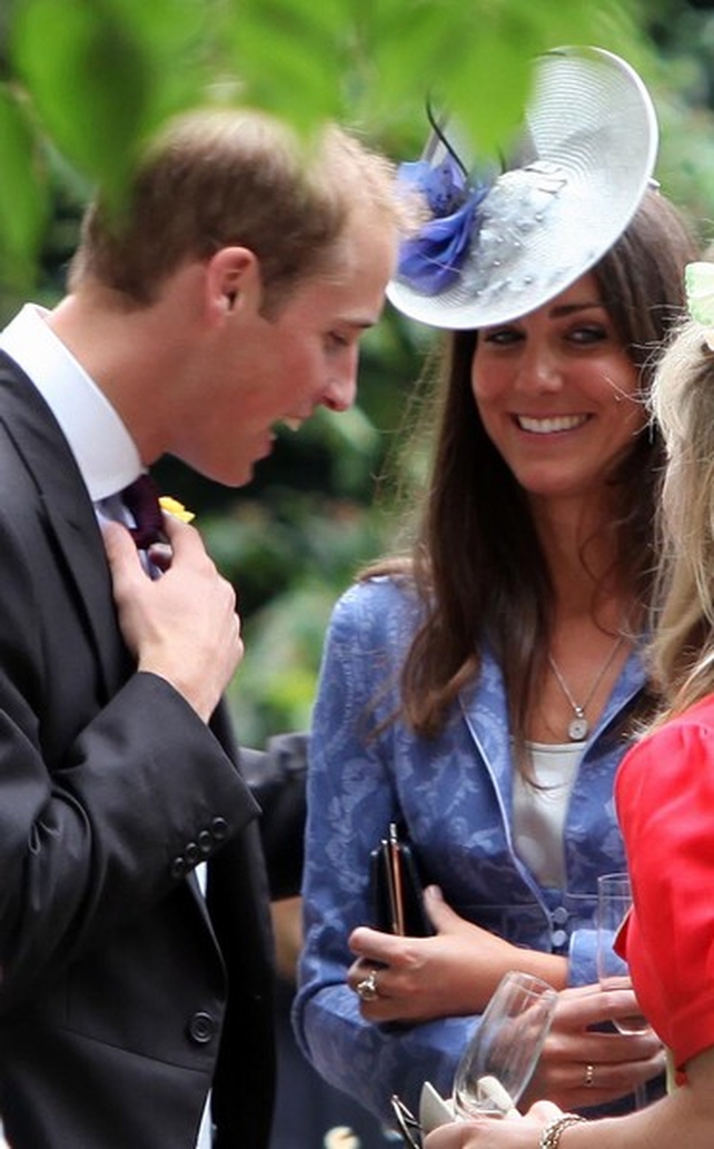 The couple chat with friends at a wedding in August 2009