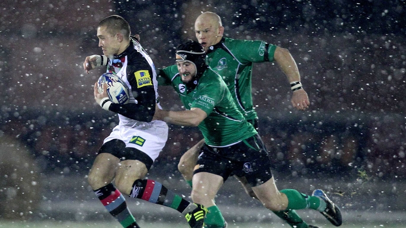 Harlequins' Mike Brown is pursued by John Muldoon and Keith Matthews at a snowy Sportsground