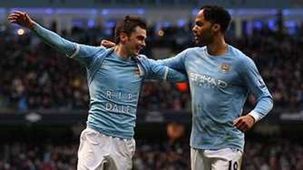 Adam Johnson (l) is congratulated by Joleon Lescott