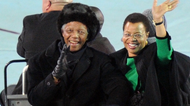 Nelson Mandela and his wife Graca Machel appear and wave to fans from the field before the 2010 football World Cup final between the Netherlands and Spain at Soccer City stadium in Soweto