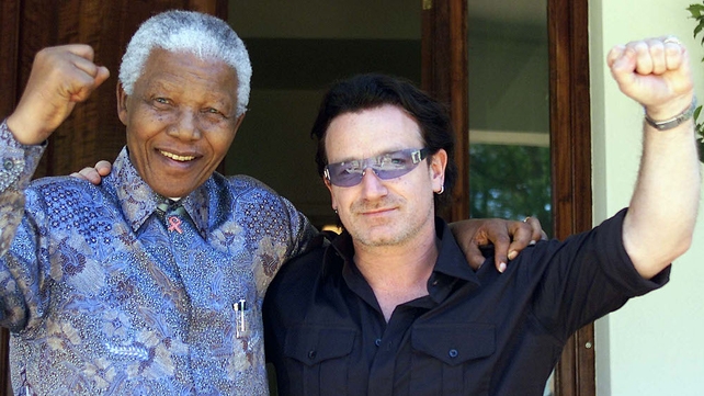 Bono and Nelson Mandela pictured after meeting at Mandela's home in Johannesburg on 25 May 2002