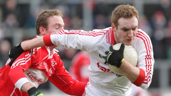 Tyrone's Aidan Cassidy with Derry's Sean Leo McGoldrick