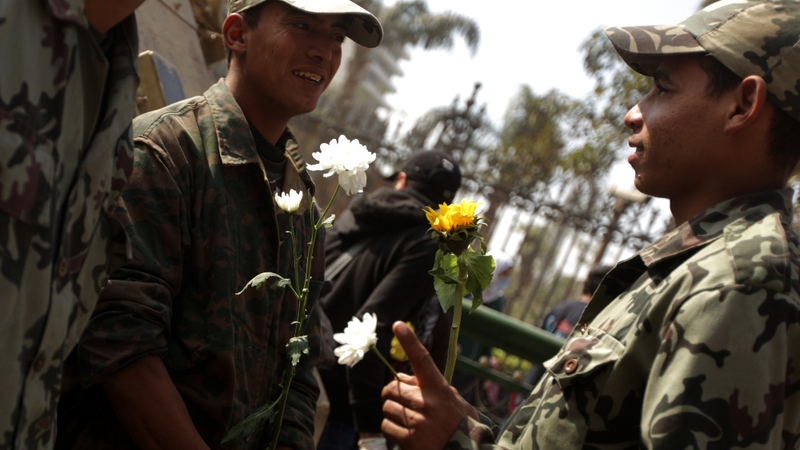 Cairo - Soldiers hold flowers a day after Mubarak stepped down