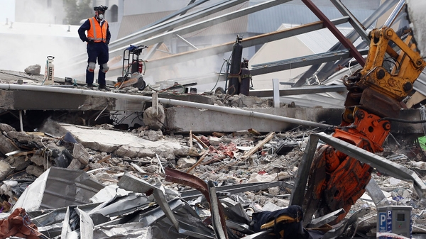 New Zealand - Rescue workers work on the remains of the CTV building