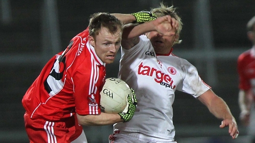 Derry's Martin Donaghy battles Tyrone's Owen Mulligan