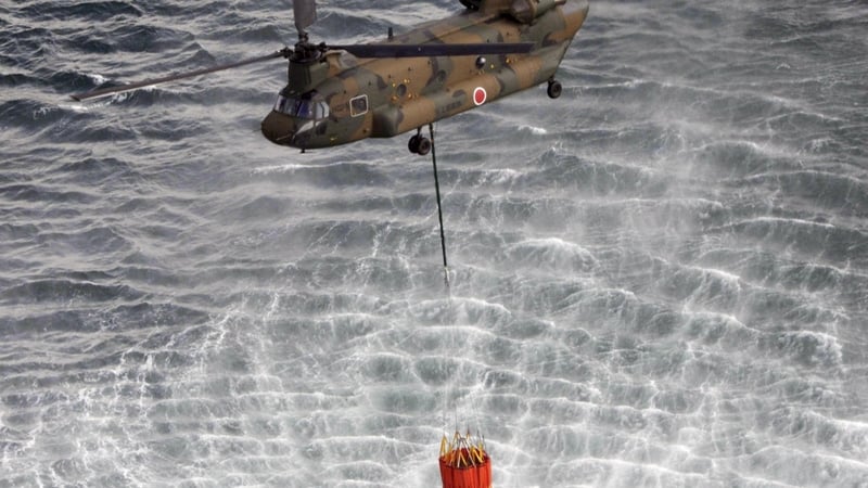 Military helicopters have been used to dump water on the reactors at Fukushima