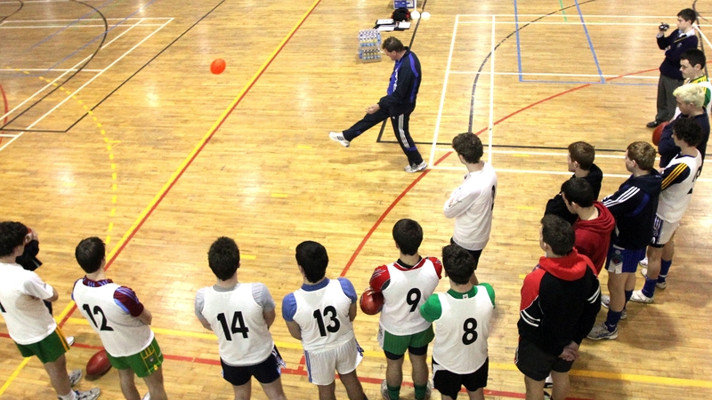 Ricky Nixon with young GAA players at an AFL trial camp in Ireland in 2010