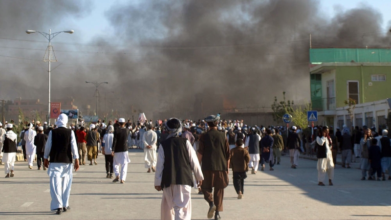 Smoke billows from the UN headquarters after protesters attacked the compound in Mazar-i-Sharif