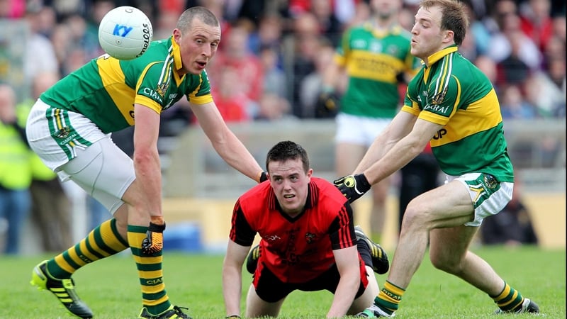 Down's Conor Garvey - closely tracked by Kerry duo Kieran Donaghy and Darran O'Sullivan