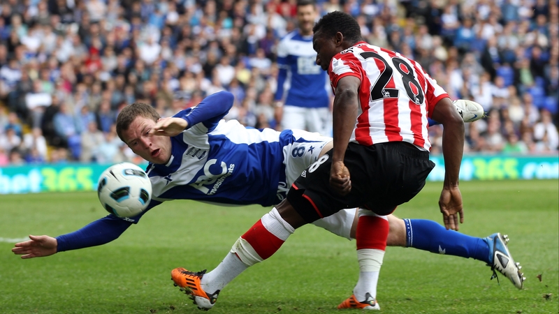 Sebastian Larsson of Birmingham is challenged by Asamoah Gyan of Sunderland