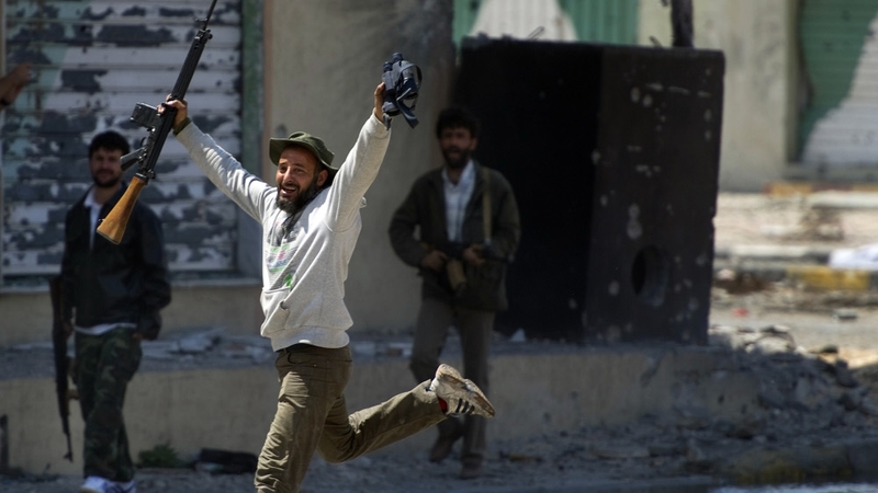 Misrata - A rebel fighter celebrates in relief after crossing a major street