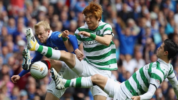 Rangers' Steven Naismith and Ki Sung-Yueng and Beram Kayal of Celtic battle for the ball