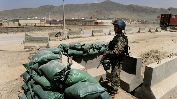 Kabul - An Afghan soldier keeps watch at the gate of the Afghan air force compound