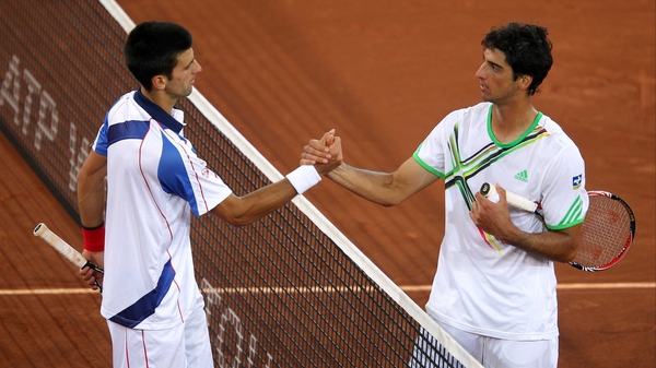 Novak Djokovic (left) - is congratulated by Thomaz Bellucci after their semi-final match in Madrid