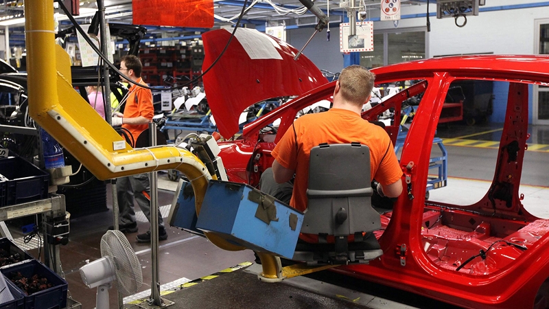 The seat allows workers to sit and glide into the car while fitting parts