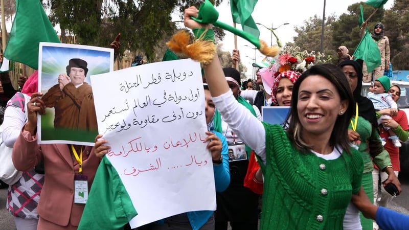 Libya - Libyan women hold pictures of Muammar Gaddafi in a rally on 22 May
