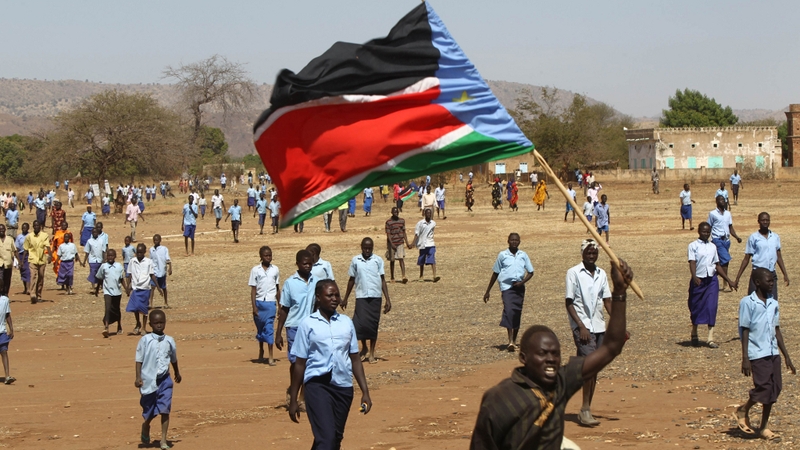 South Kordofan state - A Sudanese man waves the regional flag of southern Sudan
