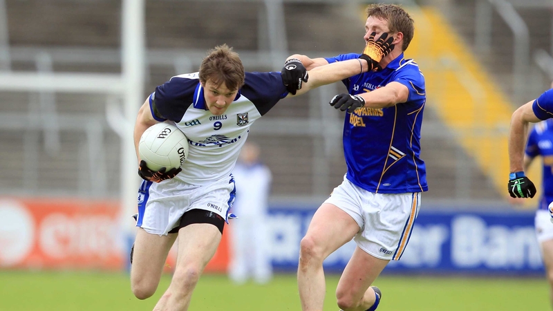 Gearoid McKiernan of Cavan holds off Longford's Noel Farrell