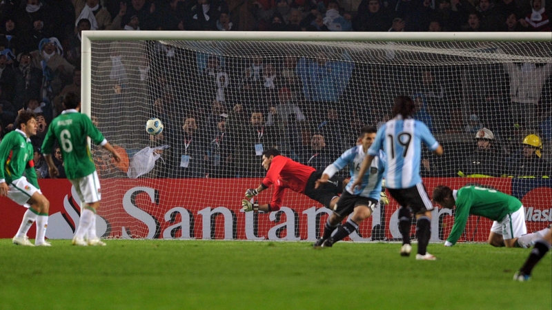 Argentine forward Sergio Aguero runs to celebrate after scoring against Bolivian goalkeeper Carlos Erwin Arias
