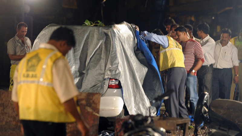 Mumbai - Police officers and experts examine the bomb blast site at Opera House