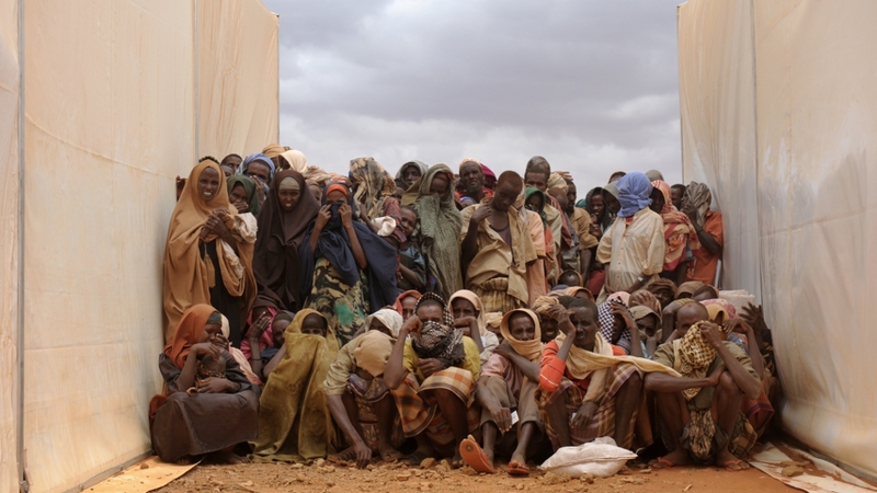 Somali refugees who recently crossed the border from Somalia cluster between two food tents