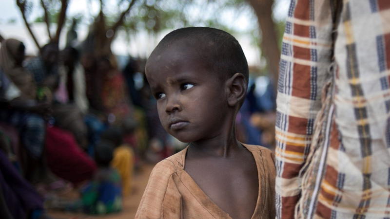 Kenya - A Somali boy waits at a Dadaab refugee compound