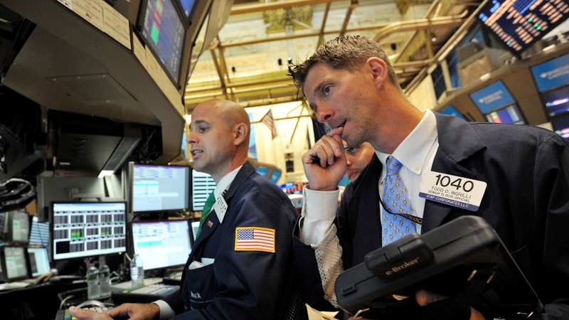 New York - A trader on the floor of the New York Stock Exchange at the opening bell
