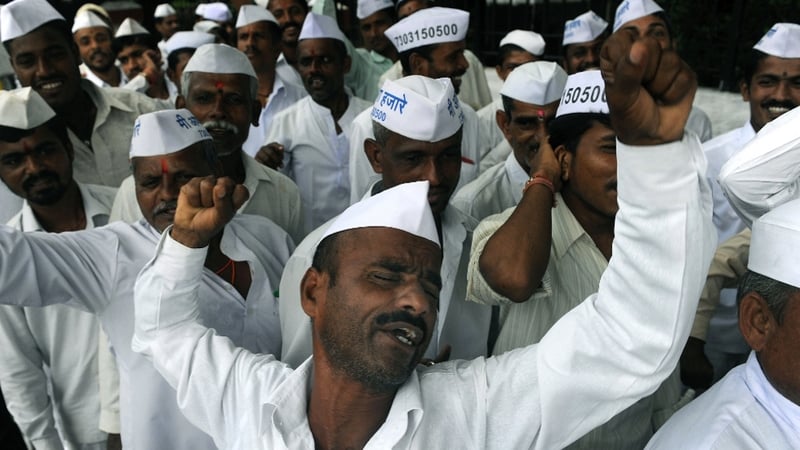 Indian dabbawallahs shout slogans during a rally in support of social activist Anna Hazare