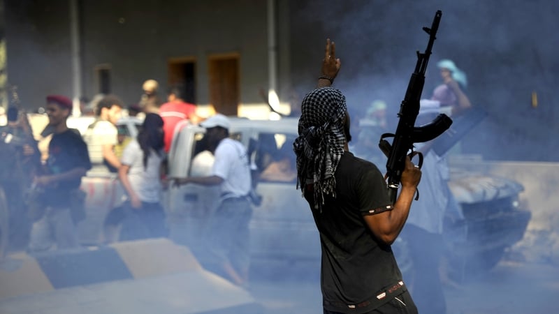 A Libyan rebel celebrates inside a captured military base