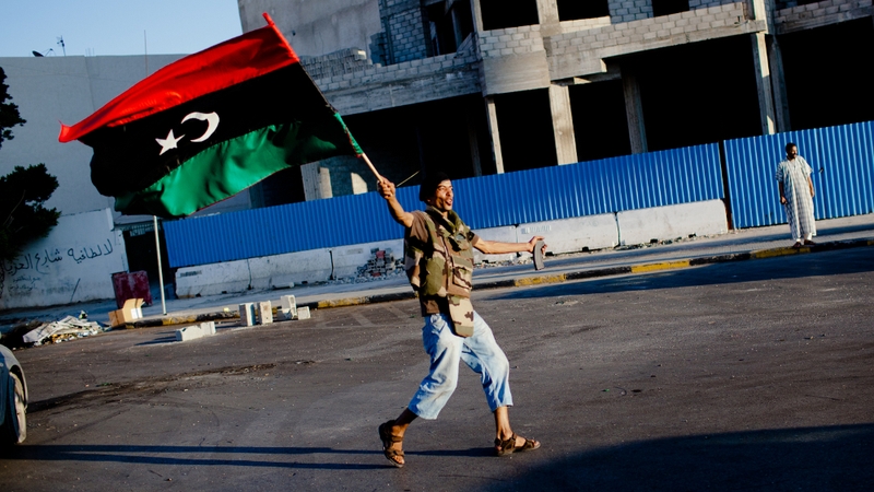 A rebel walks through the capital