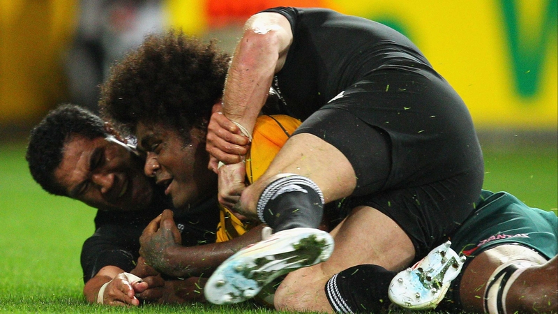 Despite the close attention of two New Zealand players, Radike Samo touches down to score Australia's second try in their Tri Nations victory over the All Blacks